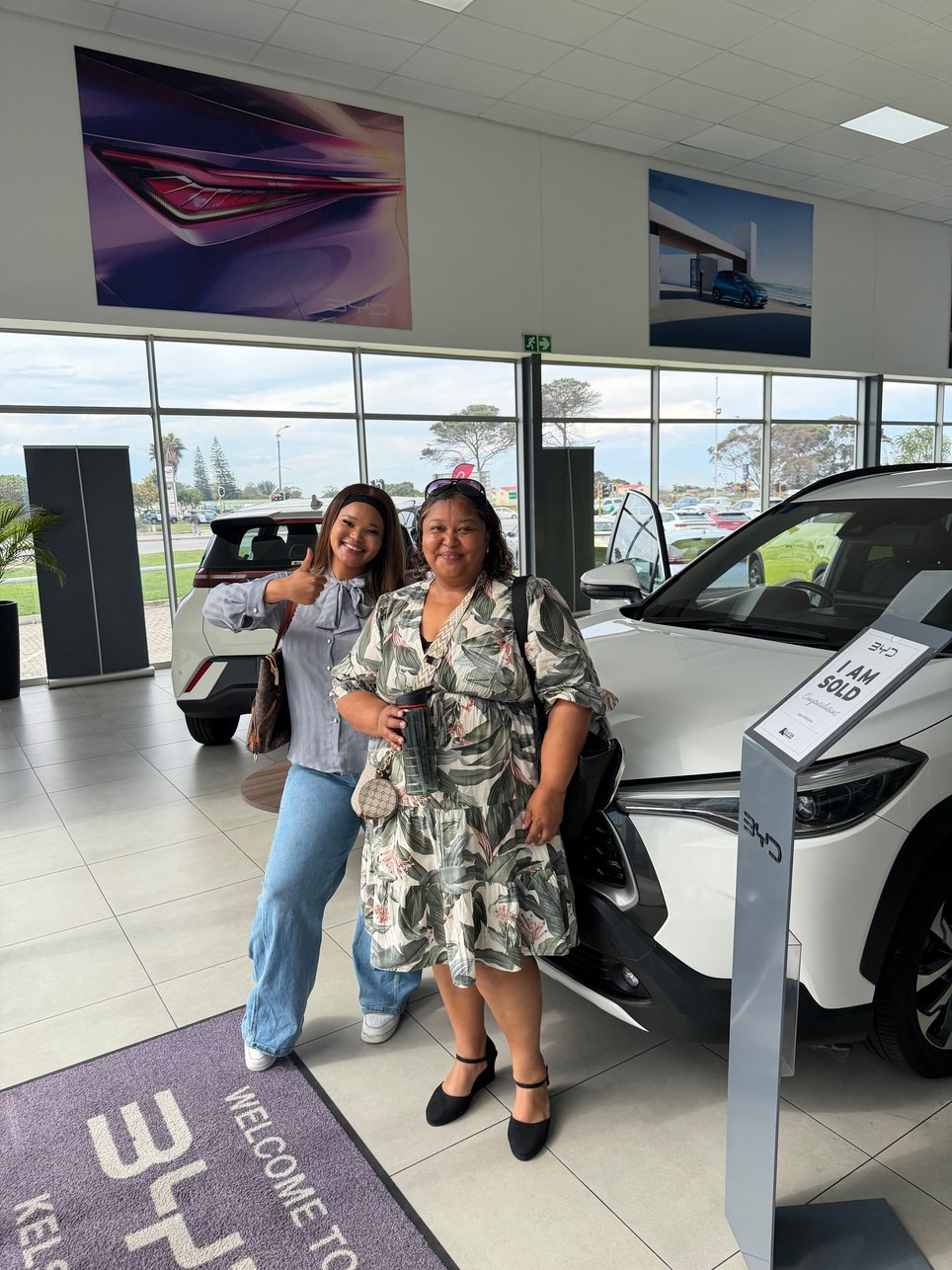 TJ Banks and her mom at the car dealership